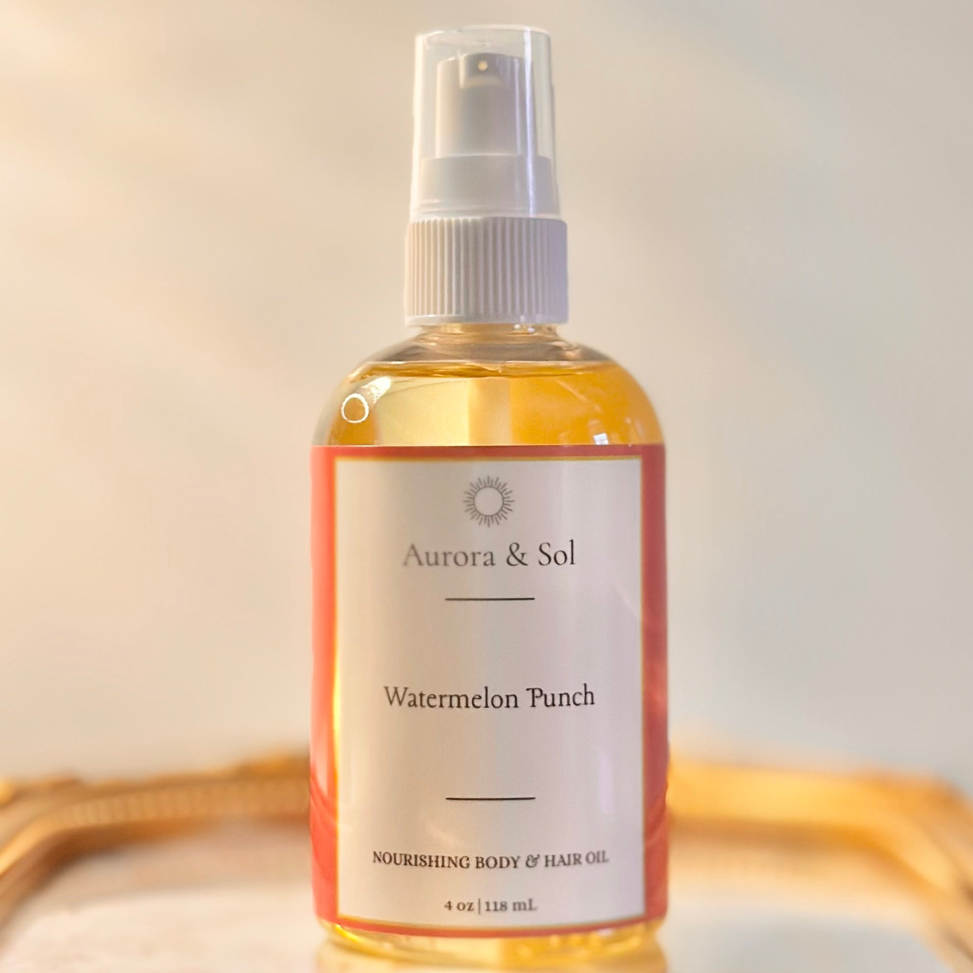 Aurora & Sol Watermelon Punch body and hair oil bottle on a neutral background