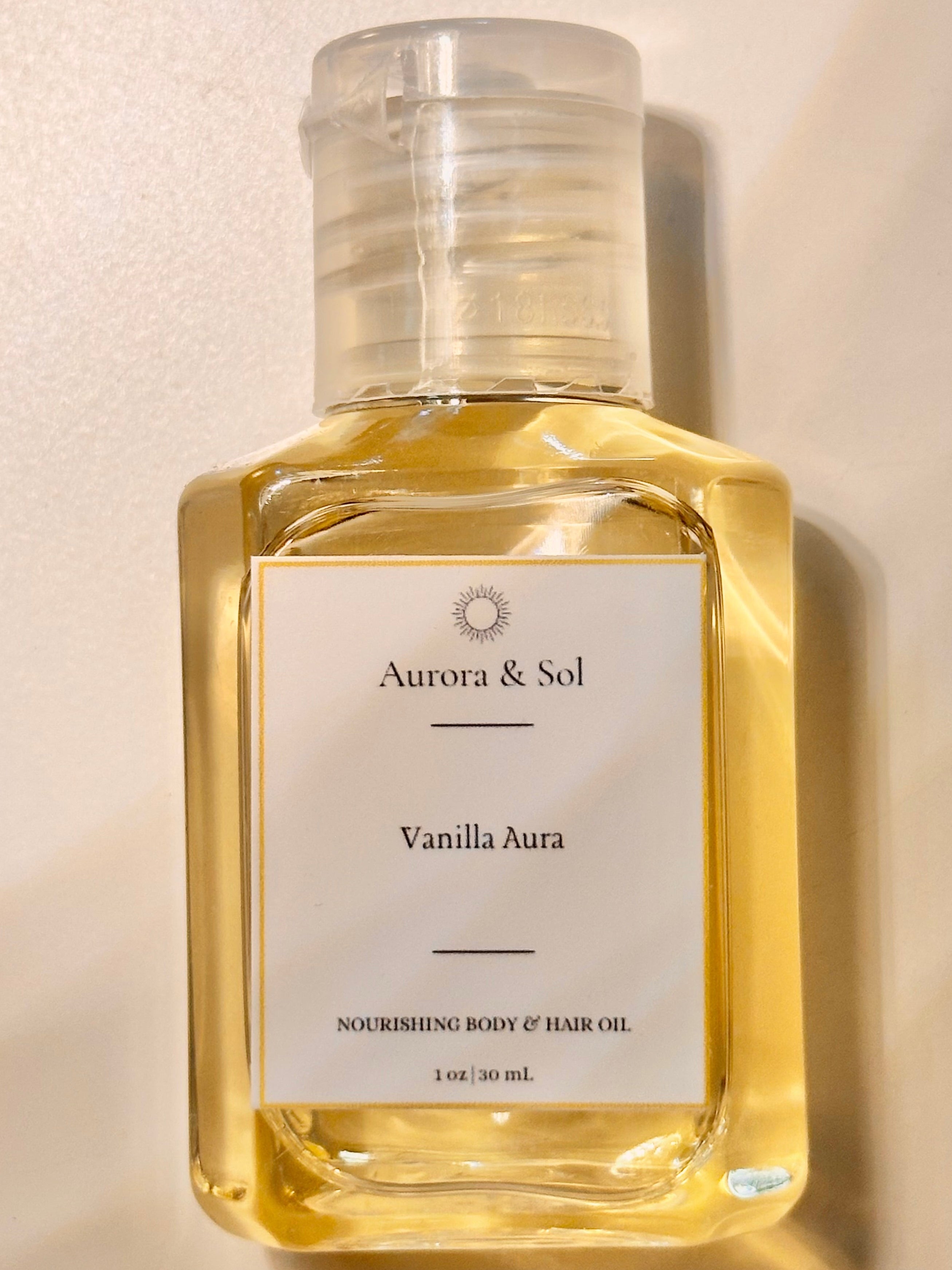 Aurora & Sol Vanilla Aura body and hair oil bottle on a beige background