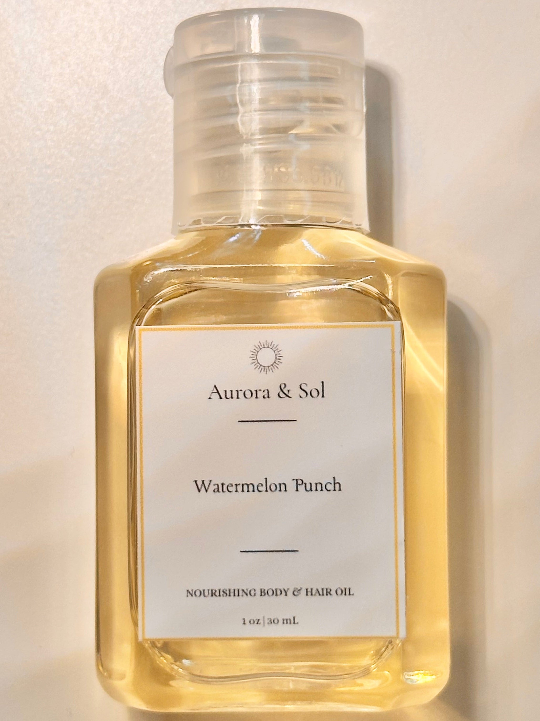 Aurora & Sol Watermelon Punch body and hair oil bottle on a light background