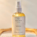 Bottle of Aurora & Sol Vanilla Aura body and hair oil on a light background