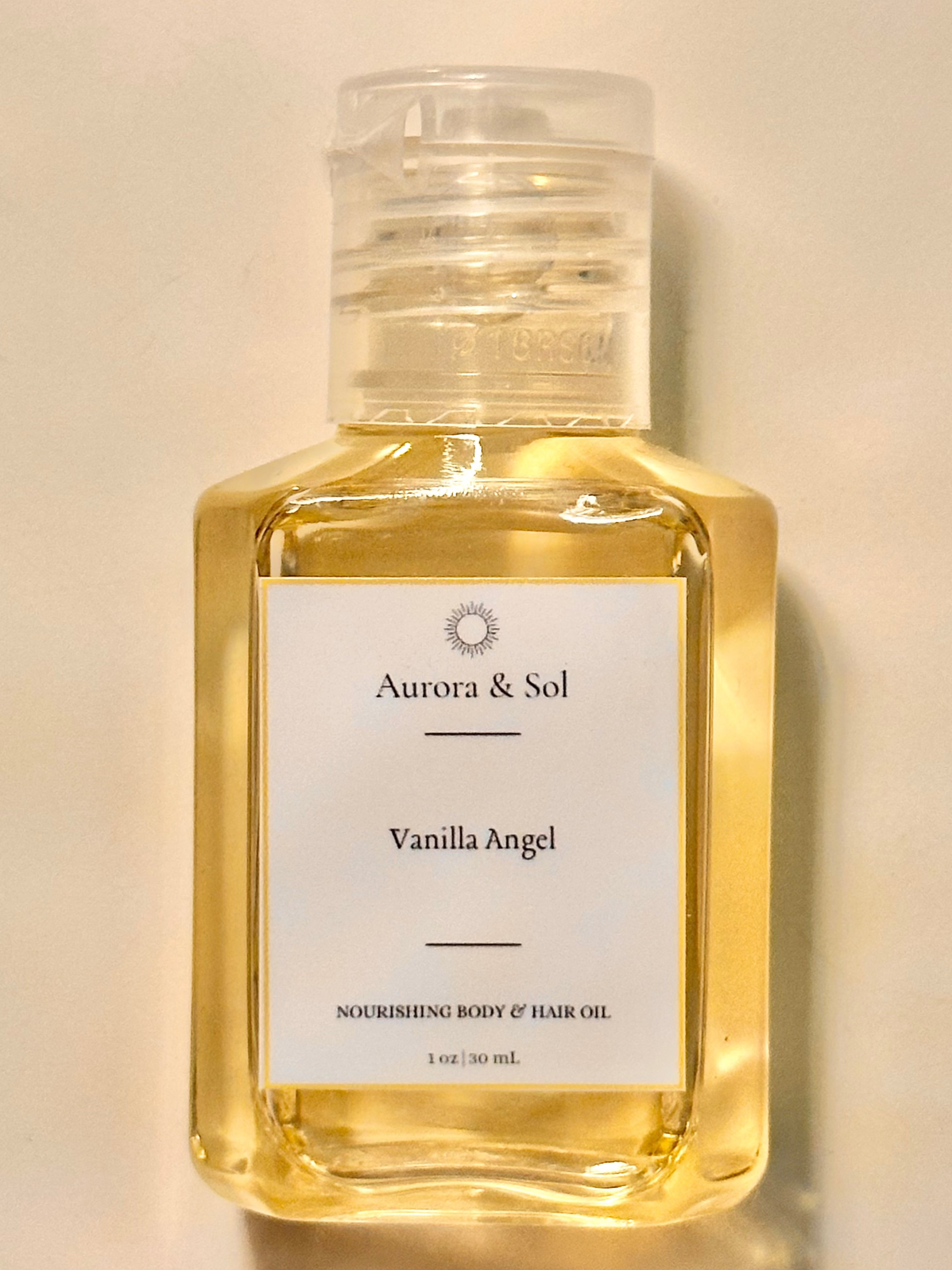 Aurora & Sol Vanilla Angel body and hair oil bottle on a beige background