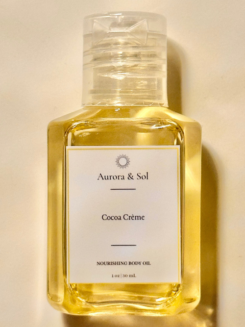 Aurora & Sol Cocoa Crème body oil bottle on a beige background