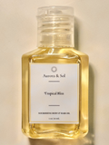 Aurora & Sol Tropical Bliss body and hair oil bottle on a beige background