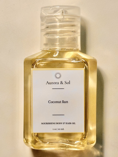 Bottle of Aurora & Sol Coconut Sun body and hair oil on a beige background